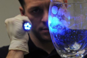 UV Light shone on glass to reveal fingerprints. [Image: Wikimedia/USAF]