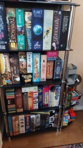 One of my board gaming shelves, with games such as Wingspan, Legacy of Dragonholt and Wavelength