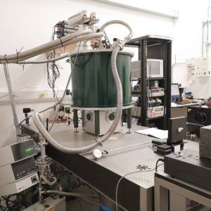 A large superconducting magnet sitting on an optical table in a physics lab
