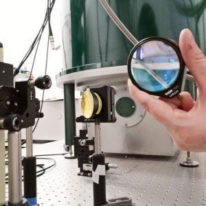 A photo of an optical table showing lenses and mirrors