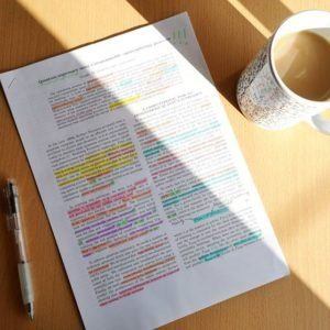 A scientific paper with various coloured highlights on it