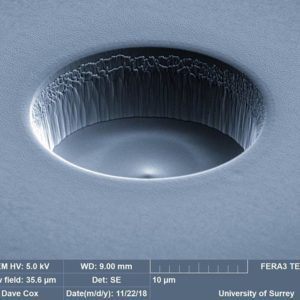 A scanning electron microscope image of a small etched hole