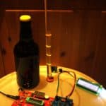 A bottle of home brewed beer together with a home made microelectronic control unit to monitor the brewing process